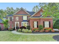 Stunning brick home featuring manicured landscaping and a classic architectural design at 125 Stoney Ridge Dr, Alpharetta, GA 30022