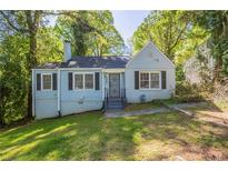 Charming light blue house with black shutters and a well-maintained front yard and mature trees in a quiet neighborhood at 1328 Lockhaven Sw Cir, Atlanta, GA 30311