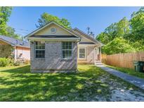 Charming brick home featuring a well-maintained lawn and inviting front entrance at 2212 Butner Sw Rd, Atlanta, GA 30331
