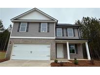 Charming two-story home featuring gray siding, brick accents, attached two-car garage, and a welcoming front porch at 123 Deer Xing, Temple, GA 30179