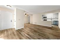Bright living room featuring hardwood floors and an open layout to kitchen and dining area at 1371 Branch Dr, Tucker, GA 30084