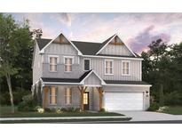 Charming two-story home boasts a modern exterior, complemented by lush landscaping, and a two-car garage at 4082 Adler Cir, Buford, GA 30519