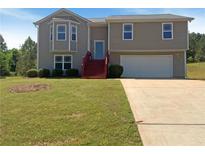 Charming two-story home featuring a bay window, red steps, and an attached two-car garage at 55 Ratliff Dr, Covington, GA 30016