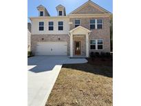 Charming two-story brick home with a well-manicured lawn and attached two-car garage at 6108 Marigold Way, Atlanta, GA 30349