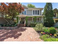 Charming home with a brick driveway and lush landscaping creating great curb appeal at 22 The Prado Ne, Atlanta, GA 30309