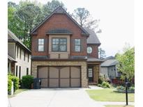 Charming two-story home with brick and shingle exterior, and a spacious two-car garage at 5122 Micaela Way, Duluth, GA 30096