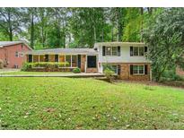 Charming two-story home with a lush green front yard and a combination brick and siding exterior at 2620 Clairmont Ne Rd, Atlanta, GA 30329