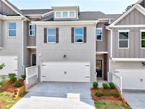New construction townhome with a two-car garage and beautifully landscaped front yard at 1227 Fern Ridge Ct # 17, Norcross, GA 30093