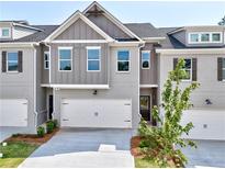 Beautiful two-story home featuring a two-car garage, brickwork and grey siding at 1237 Fern Ridge Ct # 18, Norcross, GA 30093