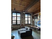 Spacious living room featuring exposed brick, large windows, and an open floor plan at 170 Boulevard Se # H414, Atlanta, GA 30312