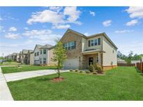 Charming two-story home boasts a well-manicured lawn and a welcoming facade at 814 Lakehaven Ln, Loganville, GA 30052