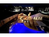 Night aerial view showcasing a pool and outdoor living space with a covered patio and lounge area at 8175 Main St, Woodstock, GA 30188