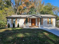 Charming one-story home with a well-manicured lawn and attractive wooden door and window shutters at 185 Glenrose Sw Cir, Atlanta, GA 30354