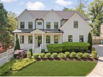 Charming two-story home with white siding, black-framed windows, manicured landscaping, and a well-maintained front yard at 1395 Oconee Ne Pass, Brookhaven, GA 30319