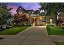 Stunning two-story home with manicured lawn and a porte cochere provides elegant curb appeal at 326 Carmichael Cir, Canton, GA 30115