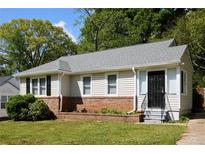 Charming single-story home with well-maintained lawn, brick facade, and new gray roof at 2179 Jernigan Drive Se Dr, Atlanta, GA 30315