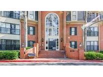 Brick exterior with large arched entry and stairs leads to the front doors of the homes at 23101 Plantation Ne Dr, Atlanta, GA 30324