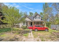 Charming two-story home with tan siding, a cozy front porch, and a well-maintained front yard at 2958 Paul Harris Rd, Dallas, GA 30157