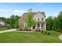 Charming two-story home with a brick and siding exterior, a well-manicured lawn, and a welcoming front porch at 13 Oakside Nw Ct, Cartersville, GA 30121