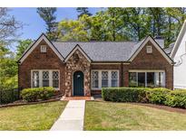 Charming brick home with stone accents and a well-manicured lawn at 1900 Ridgewood Ne Dr, Atlanta, GA 30307