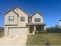 Charming two-story home with a two-car garage, and a well-maintained lawn at 375 Madison Grace Ave, Mcdonough, GA 30252