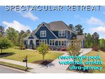 Stately two-story home with manicured lawn, mature trees, charming front porch, and inviting curb appeal at 2111 Harmony Dr, Canton, GA 30115
