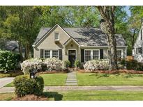 Charming home featuring a landscaped front yard and blooming azaleas beneath the windows at 2370 Hurst Ne Dr, Atlanta, GA 30305