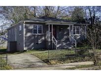 Charming single-story home with gray painted brick, a welcoming front porch, and landscaped yard at 60 Cleveland Se St, Atlanta, GA 30316