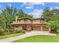 Stunning home featuring an attached two car garage, brick exterior and well manicured lawn at 1155 Mcconnell Dr, Decatur, GA 30033