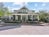 Charming two-story home with a columned front porch and meticulously landscaped front yard at 1102 Emory St, Oxford, GA 30054