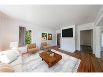 Bright living room with a fireplace, hardwood floors and stylish decor at 1685 Carroll Nw Dr, Atlanta, GA 30318
