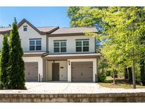 Charming townhome featuring two-car garage and well-maintained front yard at 2857 Regal Park # 3, Atlanta, GA 30318