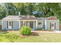 Charming craftsman-style home with a manicured lawn, quaint shutters, and inviting front entrance at 1404 E Forrest Ave, Atlanta, GA 30344