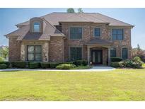 Charming brick two-story home with manicured lawn and landscaping provides beautiful curb appeal at 2365 Barrington Trace Sw Cir, Atlanta, GA 30331