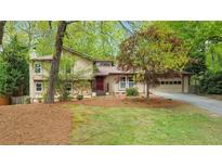 Charming exterior view of a two-story home featuring mixed siding and a well-manicured front lawn at 951 Woodmont Dr, Marietta, GA 30062
