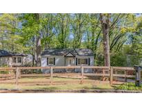 Charming single-story home with a fenced yard and mature trees offering both curb appeal and privacy at 2162 Doris Dr, Decatur, GA 30034