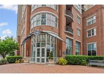 Elegant brick building entrance featuring modern architectural details and manicured landscaping at 325 E Paces Ferry Ne Rd # 312, Atlanta, GA 30305