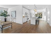 Bright, open kitchen with white cabinets, stainless steel appliances, and a large island with bar seating at 392 Pratt Dr # 2013, Atlanta, GA 30315