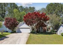 Charming single-Gathering home with a well-maintained lawn, mature trees, and inviting curb appeal at 4805 Diggers Way, Sugar Hill, GA 30518