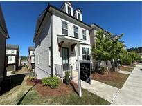 Charming two-story home with white brick, dormer windows, and a well-manicured lawn at 1329 Bennett Creek Ovlk, Suwanee, GA 30024