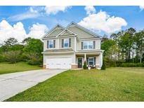 Charming two-story home with a well-manicured lawn and attached two-car garage at 74 Macland Mill Ln, Dallas, GA 30157