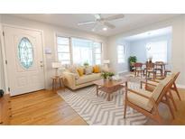 Bright living room features a ceiling fan, hardwood floors, and a seamless transition to the dining area at 145 Holly Nw Rd, Atlanta, GA 30314