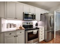 Bright kitchen features stainless steel appliances, white cabinets and stone countertops at 505 Bainbridge Dr, Atlanta, GA 30327