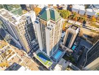 A stunning aerial view of a modern high-rise apartment building, showcasing its pool, tennis court, and prime location at 1280 W Peachtree Nw St # 2201, Atlanta, GA 30309