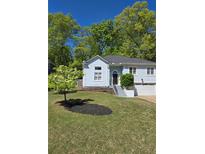 Charming home with a well-manicured lawn, attached garage and inviting entryway at 760 Whitehall Way, Roswell, GA 30076