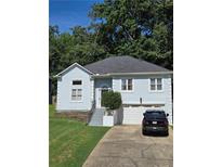 Charming home with a well-manicured lawn, classic design, and a convenient attached garage at 760 Whitehall Way, Roswell, GA 30076