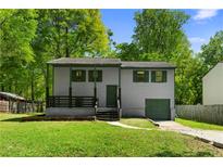 Charming two-story home featuring a covered front porch and well-maintained lawn and driveway at 6703 Cameron Rd, Morrow, GA 30260