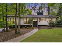 Charming one-story home with a landscaped front yard and mature trees at 230 Summerfield Dr, Alpharetta, GA 30022