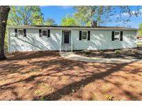 Charming single-story home with a well-manicured front yard and classic architectural details at 3795 Willowbrook Dr, Douglasville, GA 30135