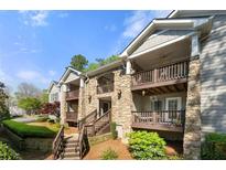 A beautiful condominium exterior with stone and wood and multiple porches at 503 Madison Se Ct, Smyrna, GA 30080
